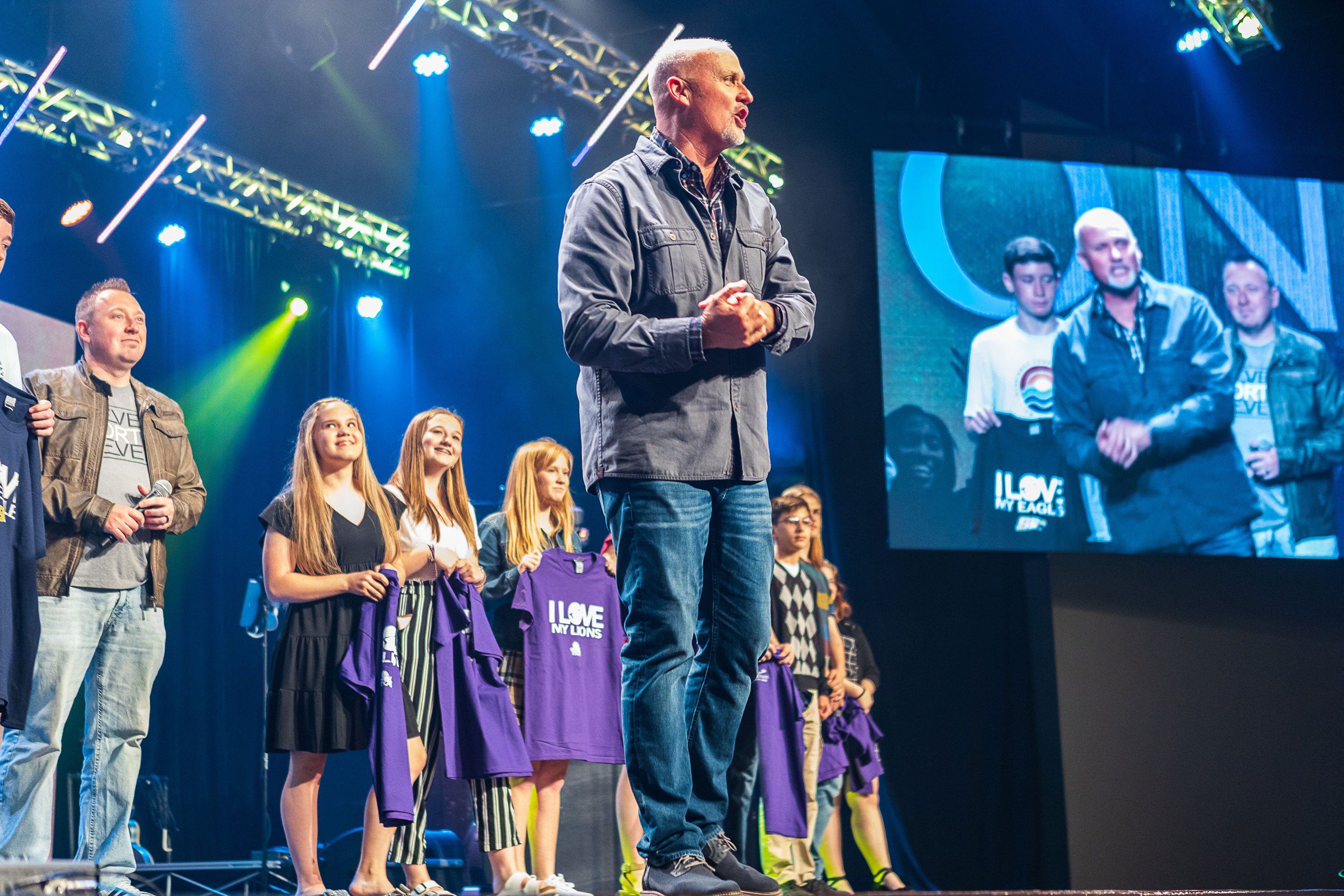high school graduates on stage with pathways church pastor
